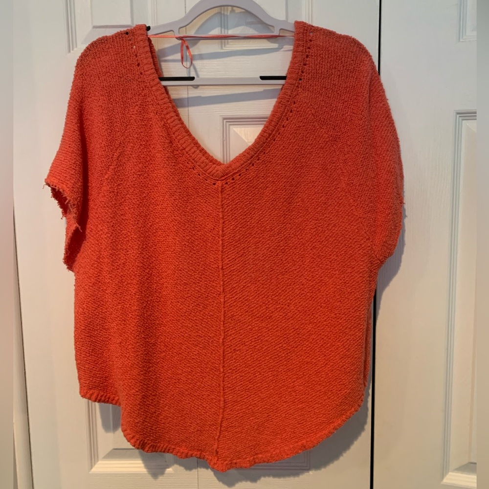 Free people short sleeve, double V sweater in coral orange.